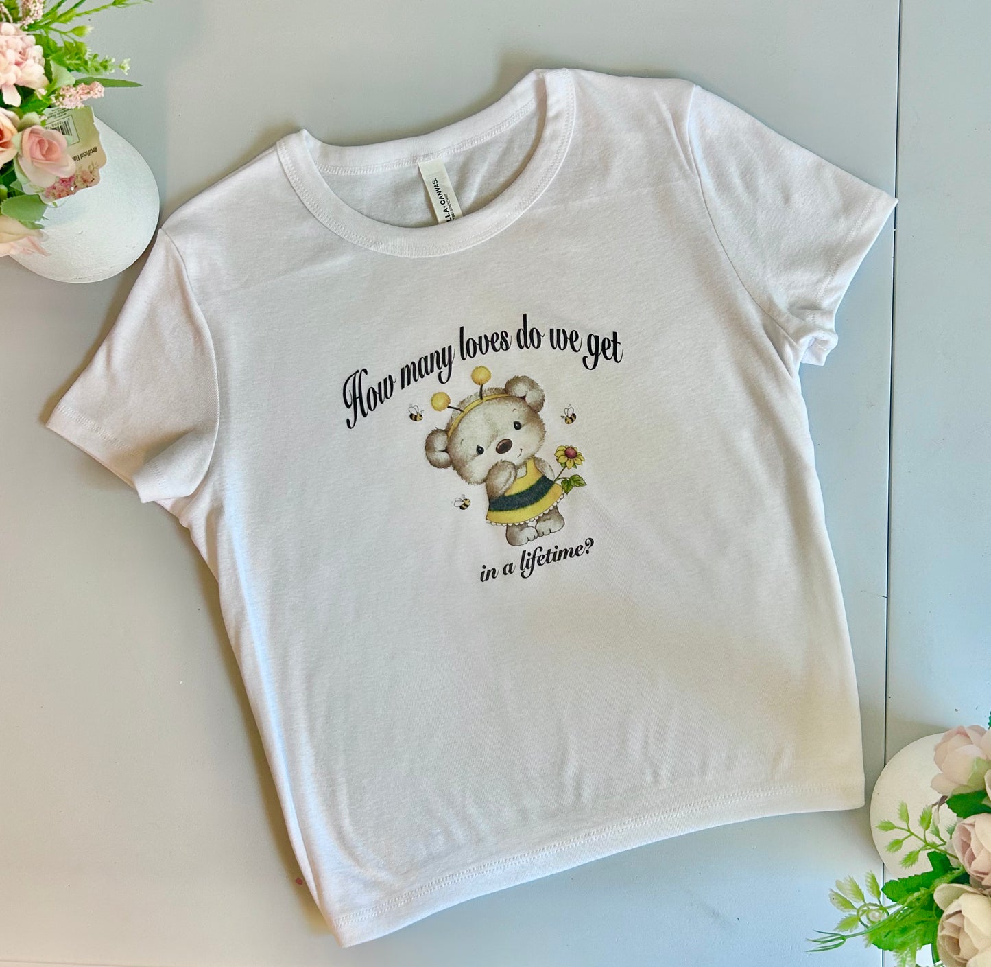 How many loves do we get in a lifetime? white short sleeve baby tee