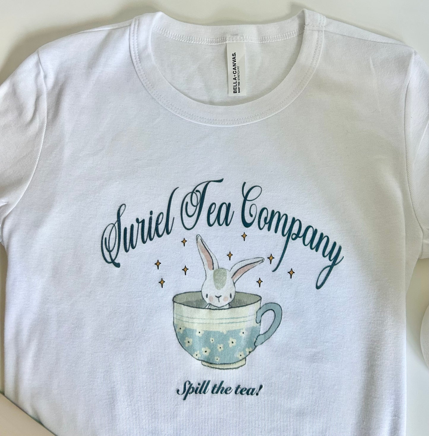 Suriel Tea Co - cute bunny in a teacup white short sleeve baby tee